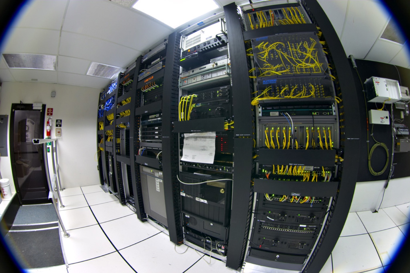 Data center hall · row upon row of server racks with cold aisles, the typical form of a 2026 hyperscaler GPU cluster